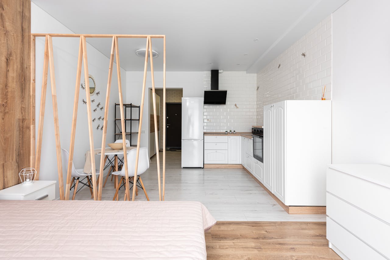 Spacious modern studio apartment featuring an open kitchen and minimalist decor.